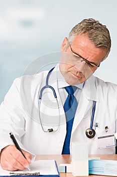 Mature doctor prescribes medical exam