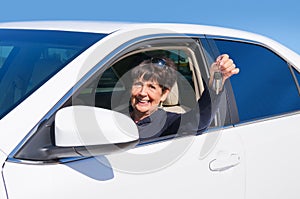 Mature elderly senior woman driver smiling w new car keys