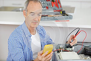 mature electrician at work