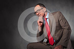 Mature elegant businessman wearing glasses and looking away