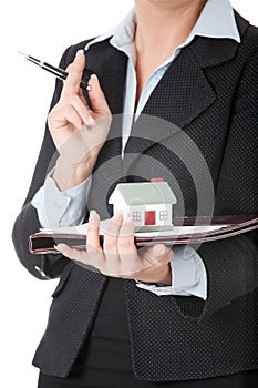 Mature engineer woman's holding house model.