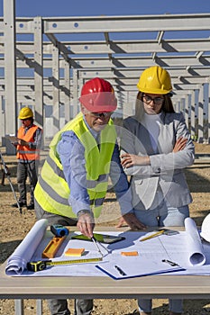 Mature Engineer and Young Female Architect Meeting at Construction Site