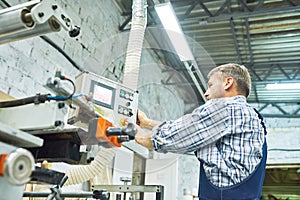 Mature Factory Workers Operating Machines