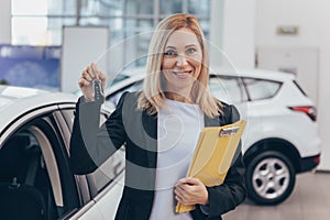 Saleswoman working at car dealership