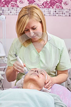 Mature female in cosmetology clinic.