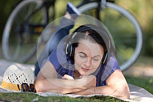 mature female cyclist taking rest in countryside