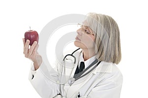 Mature female doctor holding an apple