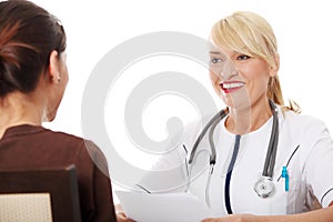 Mature female doctor talking with patient.