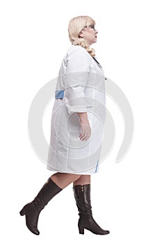 Mature female paramedic with stethoscope striding forward