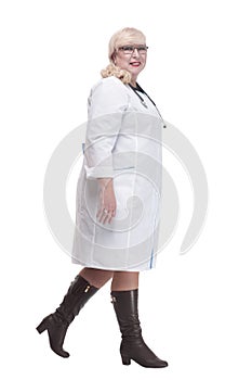 Mature female paramedic with stethoscope striding forward