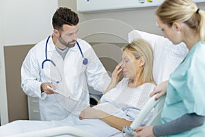 mature female patient in hospital receiving bad news from doctor