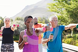 Mature fitness people exercising with dumbbells