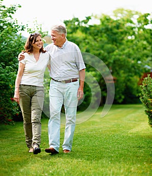 Mature, garden or happy couple hug in park or nature on a outdoor romantic walk for support. Wellness, freedom or senior