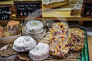 Mature goat cheese and rounds coated with flowers at a shop in Antibes, France