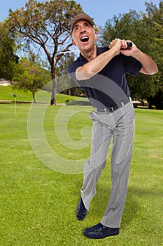 Mature golfer swinging his golf club