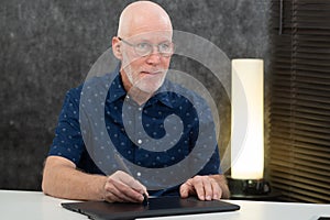 Mature graphic designer using digitized pen