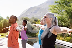 Mature group of people doing breathing exercise photo