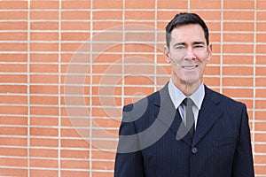 Mature handsome Caucasian businessman smiling with copy space