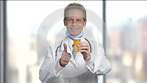 Mature handsome doctor advertising pills.