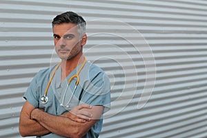 Mature handsome health care worker portrait isolated with arms crossed