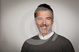 Mature handsome man smiling at the camera. Isolate on white. Happy men
