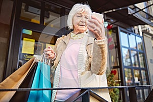 Mature happy blonde woman with shopping bags