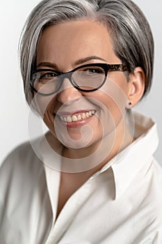 Mature happy businesswoman with glasses.