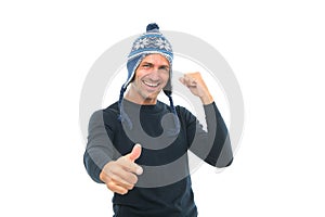 Mature happy man in knitted hat. cheerful guy pointing finger. male knitwear accessory. warm winter clothing fashion