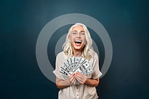 Mature happy old woman holding money.