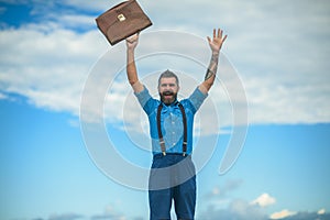 Mature hipster with beard. Brutal male. Vintage fashion bag. Going to work. Businessman. Bearded happy man with retro