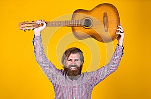 Mature hipster musician with beard. brutal caucasian guy playing guitar. country music. bearded man singing song