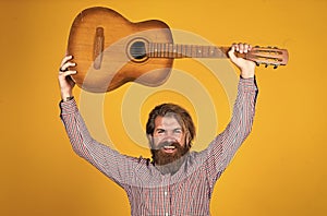 mature hipster musician with beard. brutal caucasian guy playing guitar. country music. bearded man singing song
