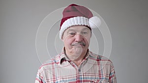 Mature hispanic sad man in christmas hat