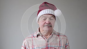 Mature hispanic sad man in christmas hat