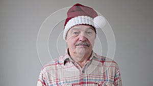 Mature hispanic sad man in christmas hat
