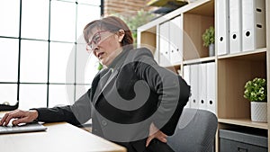 Mature hispanic woman business worker suffering for backache at office