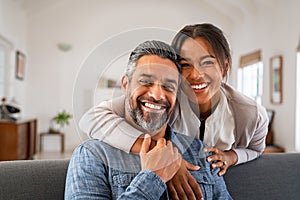 Mature indian couple hugging and looking at camera