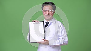 Mature Japanese man doctor wearing protective glasses