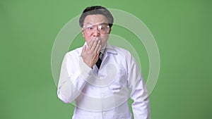 Mature Japanese man doctor wearing protective glasses