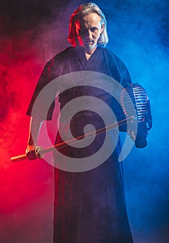 Mature kendo fighter with shinai