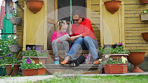 Mature Lady with Granddaughter Drawing Outdoors