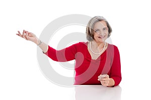 Mature lady makes advertising - elder woman isolated on white ba