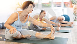 Mature lady performs Janu shirshasana