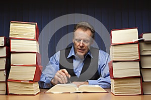 Mature lawyer, judge or office worker reading at a desk