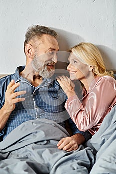 A mature loving couple, dressed in
