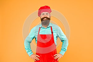 mature male chef on yellow backdrop. man cooking on kitchen. Professional chef man excited and smiling. excellent cook