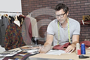 Mature male fashion designer working in design studio