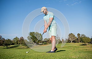 mature male golf player on professional course with green grass, golf course