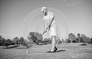 mature male golf player on professional course with green grass, golf course