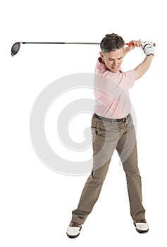 Mature Male Golfer Swinging Golf Club